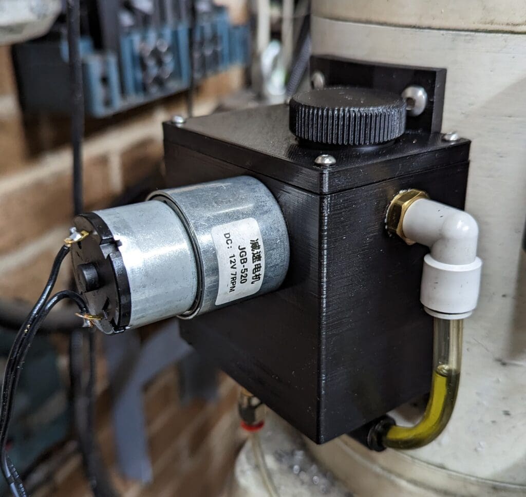 The 3D printed oil reservoir and its actuating motor.